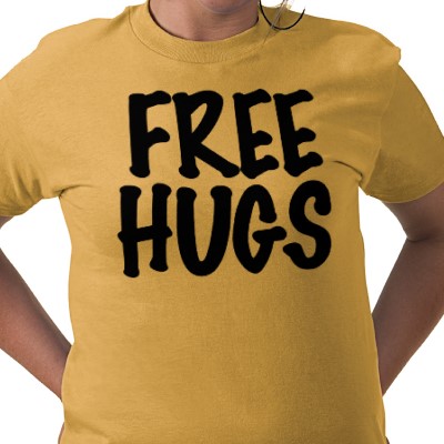 Yellow T-shirt with free hugs text.