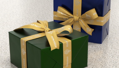 Custom gold branded ribbons on wrapped gift boxes.