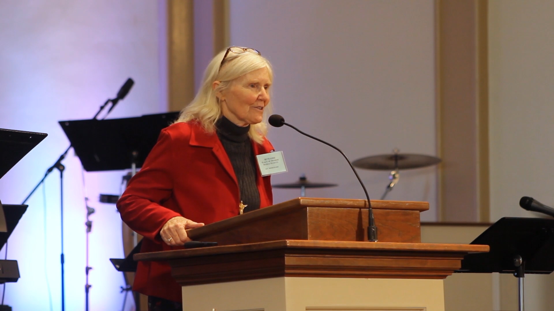 A woman speaking at a podium.