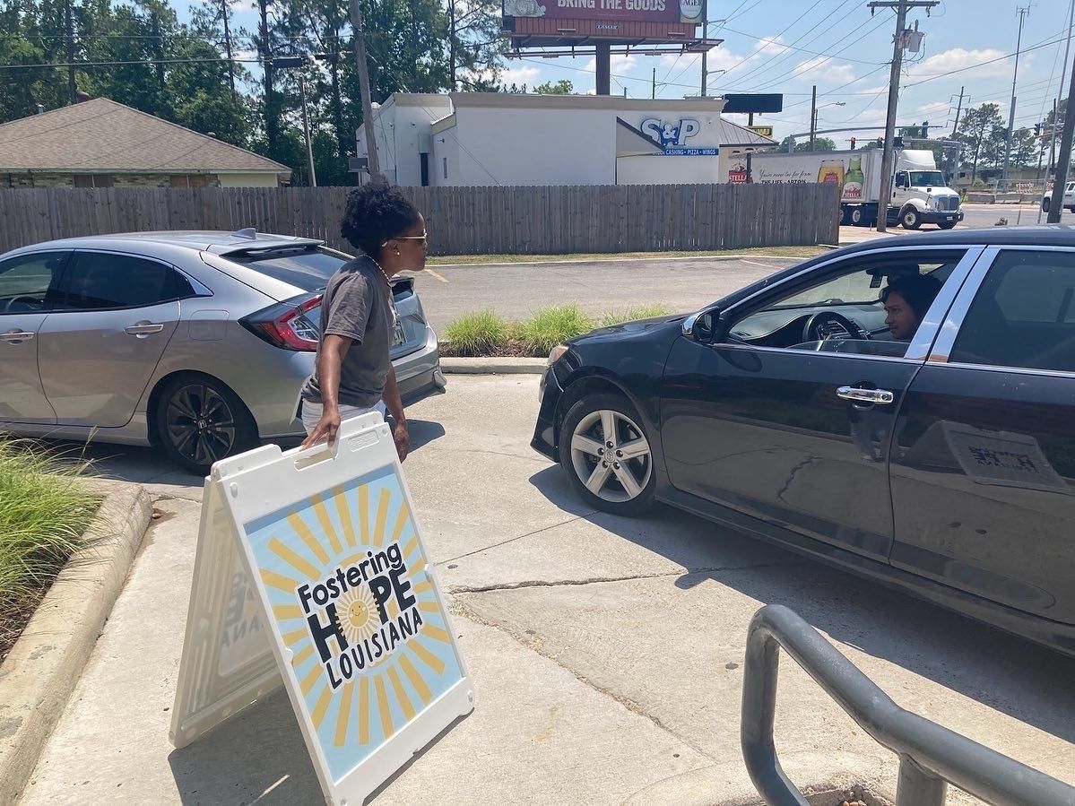 Person carrying an A-frame sidewalk sign