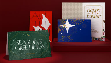 Assorted greeting cards displayed on a red shelf.