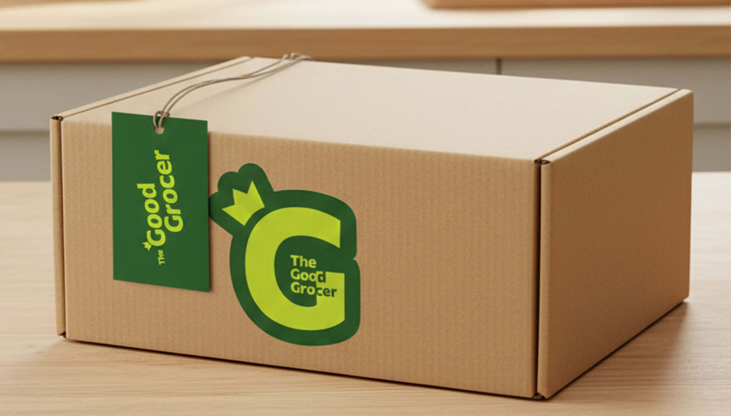 Cardboard box with The Good Grocer logo.