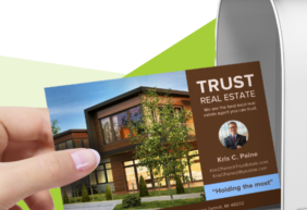 Real estate postcard entering a mailbox.